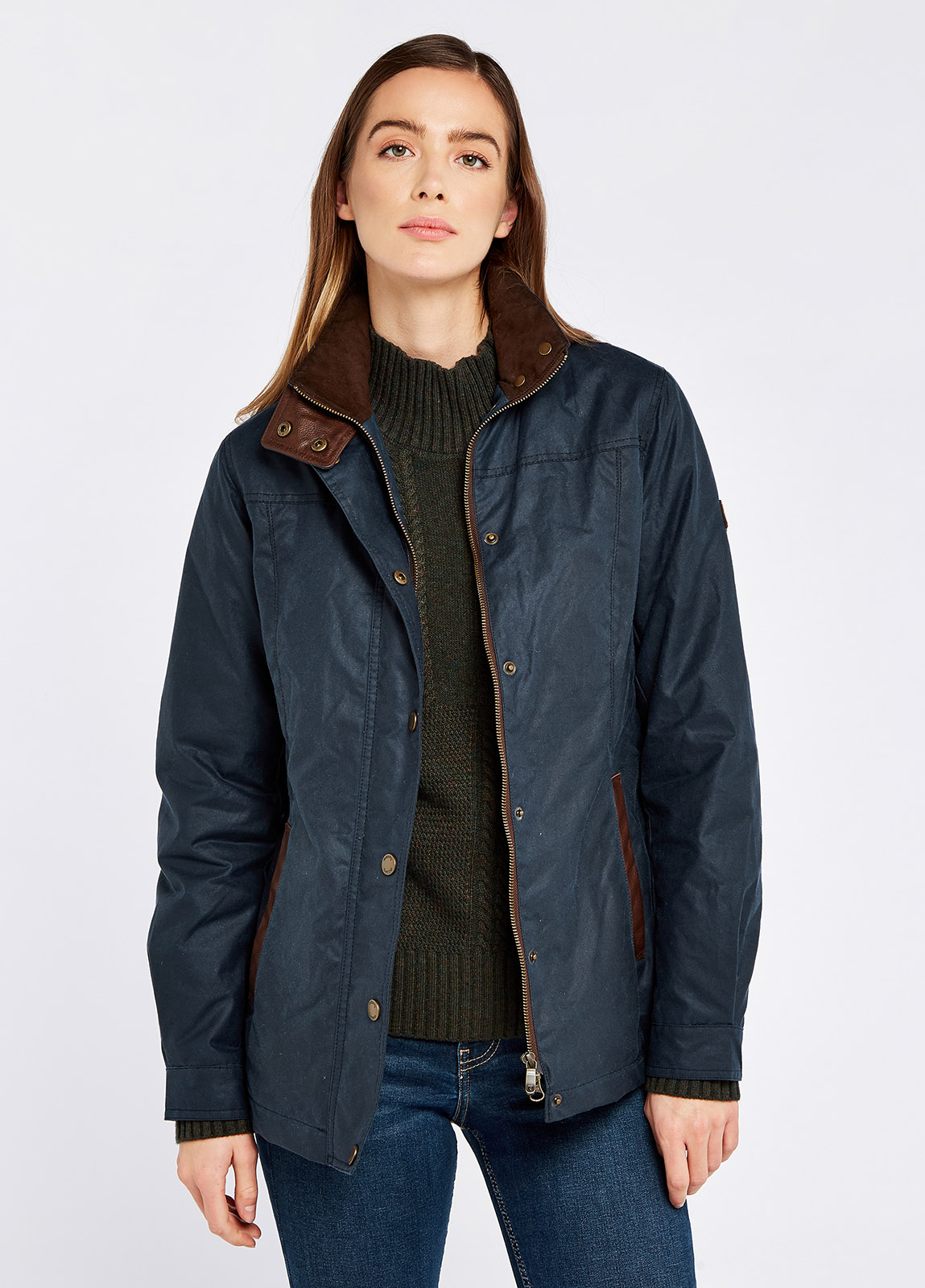 Waist up view of a female model wearing a Dubarry Mountrath Waxed jacket, ocean blue coloured jacket with full zip and buttons, brown edged pockets, inner collar and brown inside collar