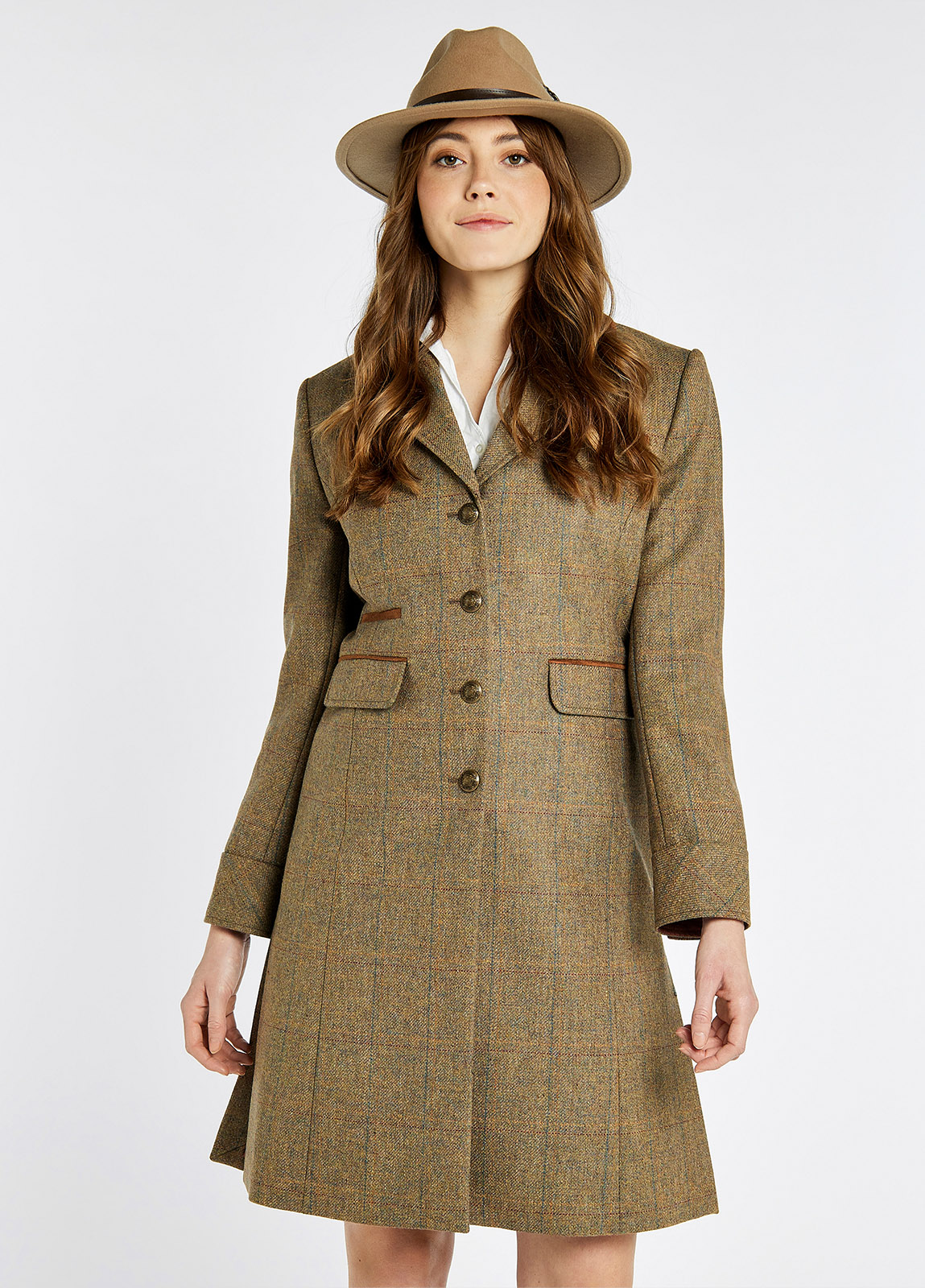A woman modelling Dubarry women's Blackthorn Tweed Burren Jacket. A three-quarter-length tailored jacket buttoned all the way with besom pockets.